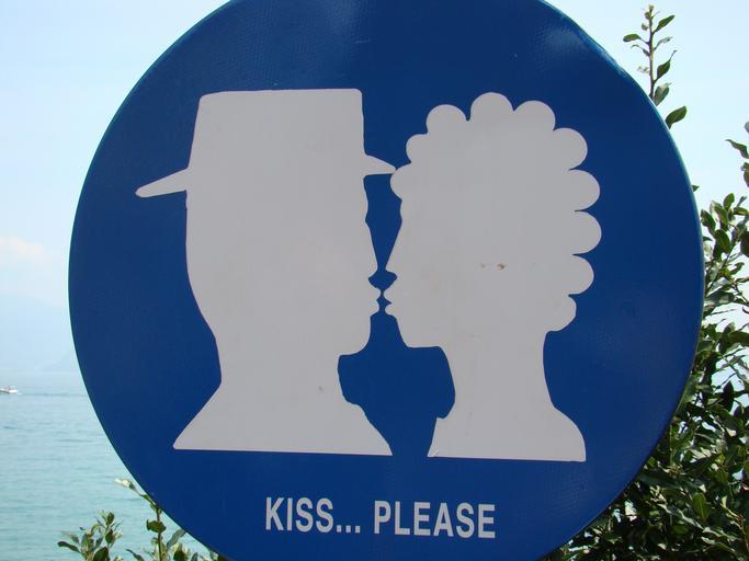 Modrá tabuľa s postavičkami muža a ženy, ktoré sa bozkávajú